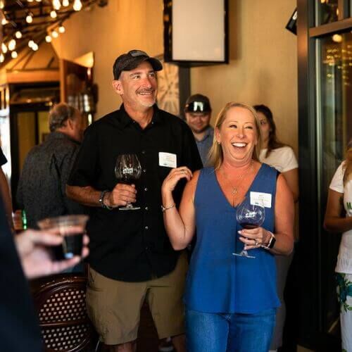 Deb Radcliff, owner of Side Door, laughs in a photo at an evening event the Chamber hosted at their wine shop